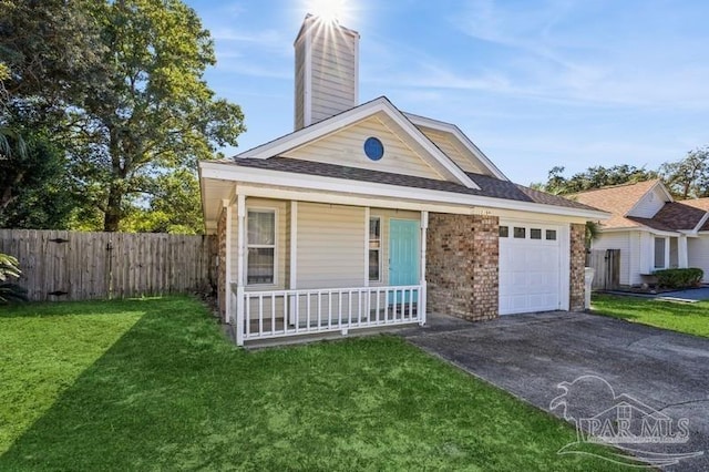 view of front of home featuring a garage, covered porch, and a front lawn