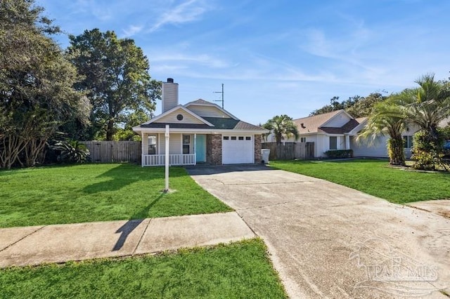 view of front of house featuring a garage, a front lawn, and covered porch