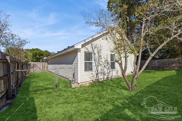 view of side of home with a yard