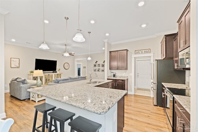5622 Dunridge Dr, Pace, FL 32571 - kitchen featuring appliances with stainless steel finishes, a kitchen island with sink, dark brown cabinetry, a ceiling fan, and crown molding