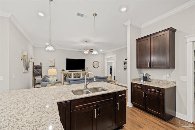 5622 Dunridge Dr, Pace, FL 32571 - kitchen with open floor plan, a ceiling fan, dark brown cabinets, ornamental molding, and recessed lighting