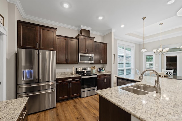 5622 Dunridge Dr, Pace, FL 32571 - kitchen with appliances with stainless steel finishes, dark brown cabinetry, wood finished floors, a chandelier, and pendant lighting