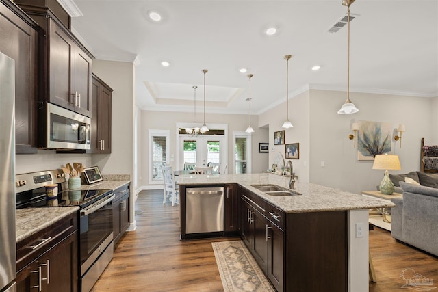 5622 Dunridge Dr, Pace, FL 32571 - kitchen featuring appliances with stainless steel finishes, dark brown cabinetry, open floor plan, dark wood finished floors, and recessed lighting