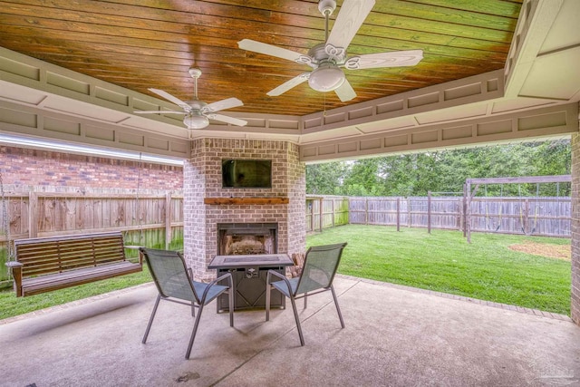 5622 Dunridge Dr, Pace, FL 32571 - fenced backyard featuring an outdoor brick fireplace, a patio, and ceiling fan