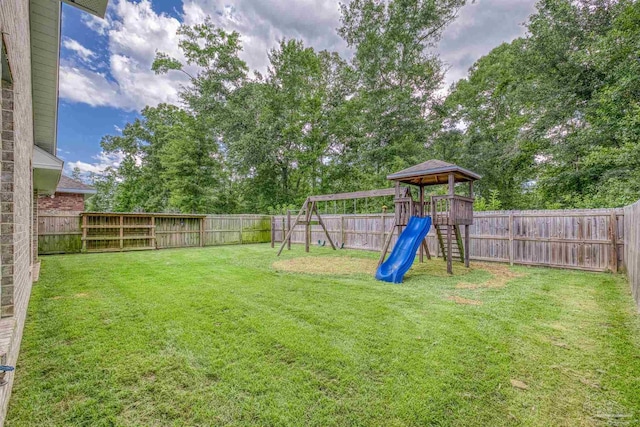 5622 Dunridge Dr, Pace, FL 32571 - fenced backyard with a playground and view of scattered trees