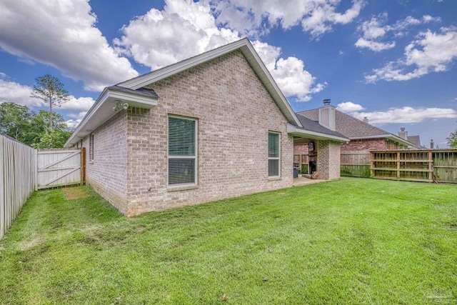 5622 Dunridge Dr, Pace, FL 32571 - back of property with brick siding, a fenced backyard, and a gate