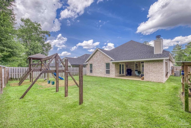 5622 Dunridge Dr, Pace, FL 32571 - rear view of house with a playground, a shingled roof, a chimney, brick siding, and a fenced backyard