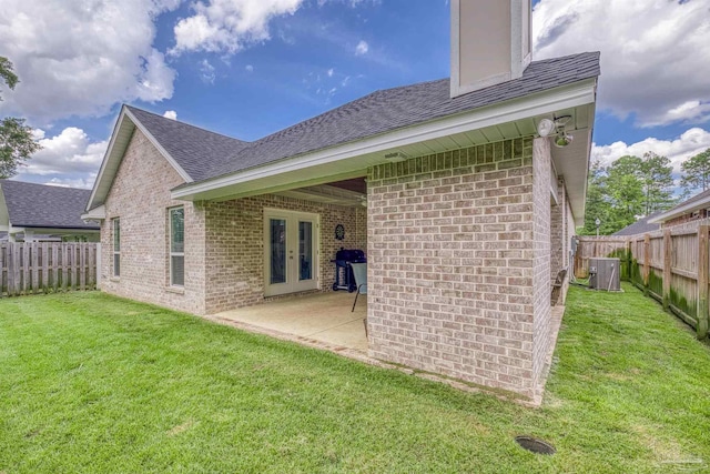 5622 Dunridge Dr, Pace, FL 32571 - back of house featuring french doors, brick siding, a fenced backyard, and a shingled roof