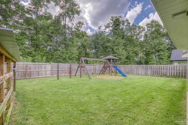 5622 Dunridge Dr, Pace, FL 32571 - fenced backyard with a playground and view of wooded area