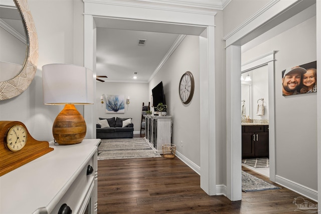 5622 Dunridge Dr, Pace, FL 32571 - hallway with dark wood-style flooring and crown molding