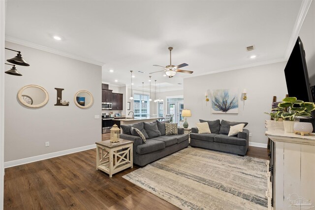 5622 Dunridge Dr, Pace, FL 32571 - living area with dark wood-style floors, ceiling fan, crown molding, a chandelier, and recessed lighting