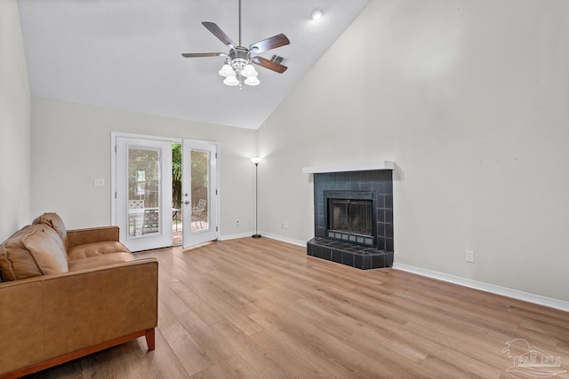 3514 Silvertree Ln, Pensacola, FL 32504 - living room featuring high vaulted ceiling, light wood finished floors, baseboards, ceiling fan, and a tiled fireplace