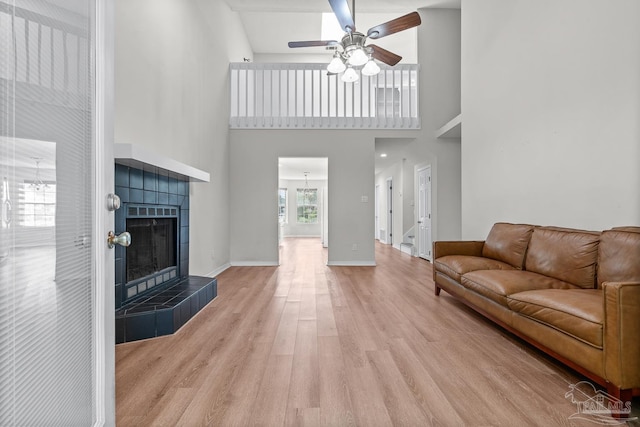 3514 Silvertree Ln, Pensacola, FL 32504 - living room featuring a ceiling fan, wood finished floors, a fireplace, a high ceiling, and baseboards