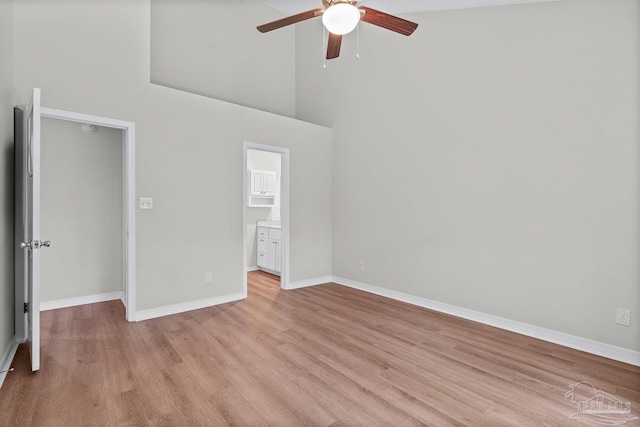 3514 Silvertree Ln, Pensacola, FL 32504 - unfurnished bedroom with light wood-type flooring, baseboards, a towering ceiling, ceiling fan, and ensuite bathroom