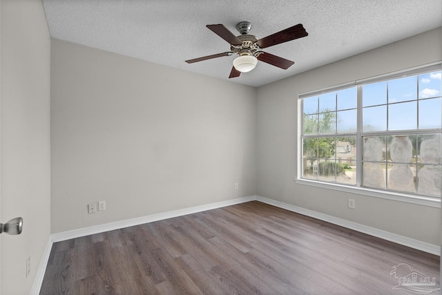 3514 Silvertree Ln, Pensacola, FL 32504 - spare room featuring wood finished floors, baseboards, a ceiling fan, and a textured ceiling