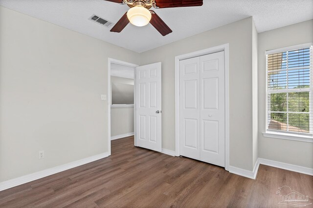3514 Silvertree Ln, Pensacola, FL 32504 - unfurnished bedroom with wood finished floors, baseboards, a closet, and a ceiling fan