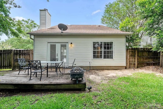 3514 Silvertree Ln, Pensacola, FL 32504 - back of property featuring a wooden deck, a fenced backyard, outdoor dining area, an outdoor fire pit, and a chimney