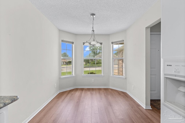 3514 Silvertree Ln, Pensacola, FL 32504 - unfurnished dining area featuring wood finished floors, a textured ceiling, and baseboards