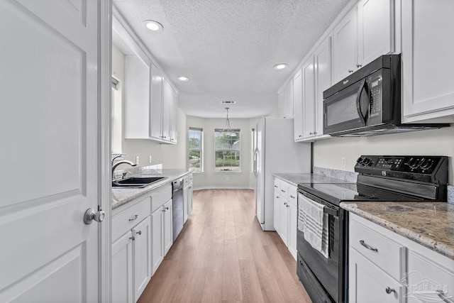 3514 Silvertree Ln, Pensacola, FL 32504 - kitchen featuring black appliances, a sink, white cabinetry, light wood finished floors, and a textured ceiling