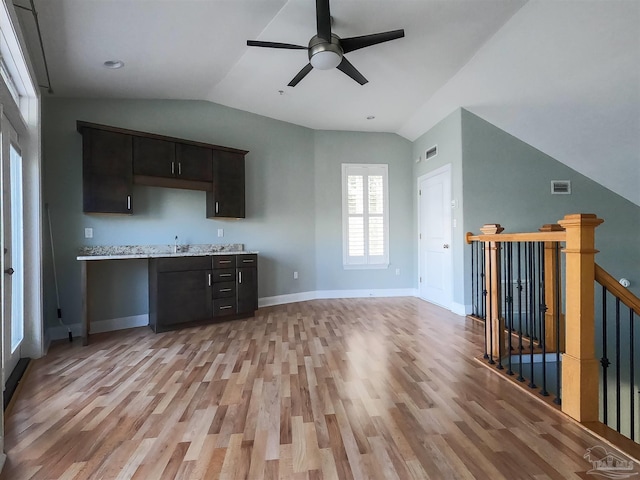 kitchen with light wood-type flooring, ceiling fan, and dark brown cabinetry