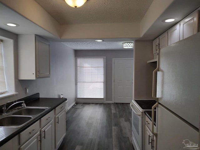 kitchen featuring white cabinetry, white appliances, sink, and a textured ceiling