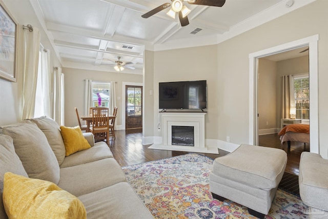 living room featuring coffered ceiling, visible vents, baseboards, and wood finished floors