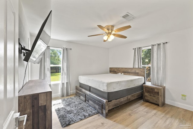 4224 Seaport Rd, Pace, FL 32571 - bedroom featuring light wood-style flooring, baseboards, and a ceiling fan