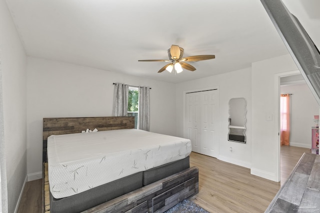 4224 Seaport Rd, Pace, FL 32571 - bedroom with light wood-type flooring, baseboards, a closet, and a ceiling fan
