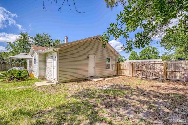 4224 Seaport Rd, Pace, FL 32571 - back of house with a fenced backyard, a gate, and a gazebo