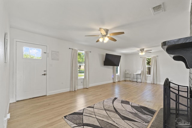 4224 Seaport Rd, Pace, FL 32571 - living area with a ceiling fan, light wood-type flooring, and baseboards