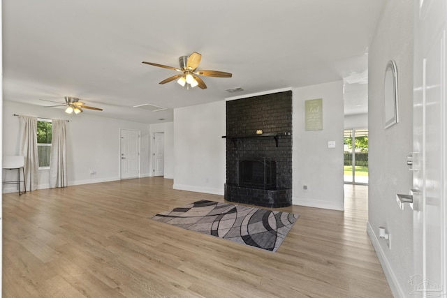 4224 Seaport Rd, Pace, FL 32571 - unfurnished living room featuring a ceiling fan, healthy amount of natural light, light wood-style floors, and baseboards