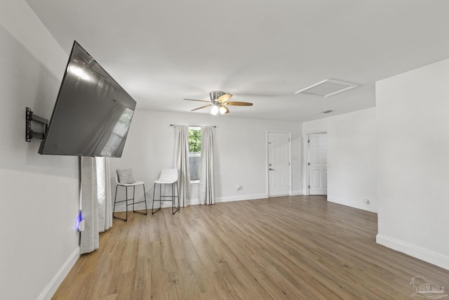 4224 Seaport Rd, Pace, FL 32571 - unfurnished living room with wood finished floors, attic access, and baseboards