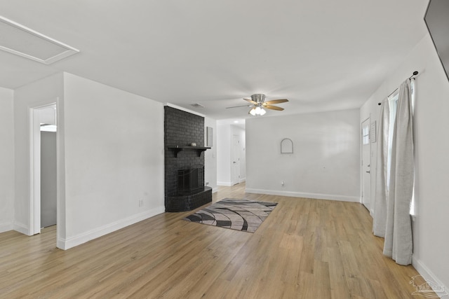 4224 Seaport Rd, Pace, FL 32571 - unfurnished living room featuring a ceiling fan, light wood-style floors, baseboards, and a brick fireplace