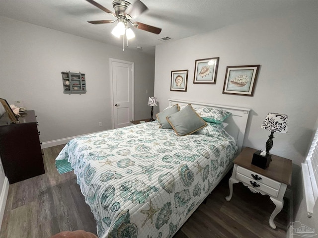 bedroom with dark hardwood / wood-style floors and ceiling fan