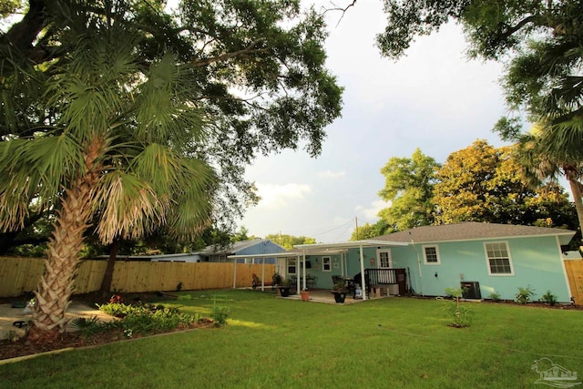 rear view of house featuring a patio area, cooling unit, and a lawn