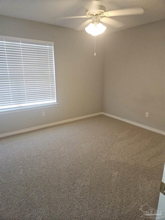 spare room featuring ceiling fan and carpet flooring