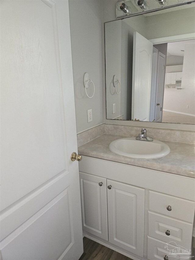 bathroom with vanity and wood-type flooring