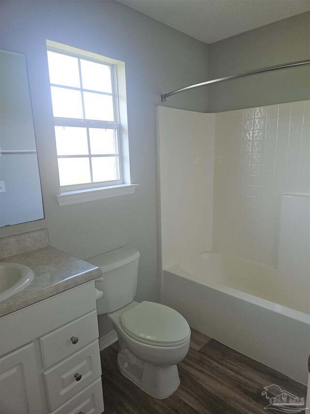 full bathroom with vanity, toilet, hardwood / wood-style floors, and shower / washtub combination