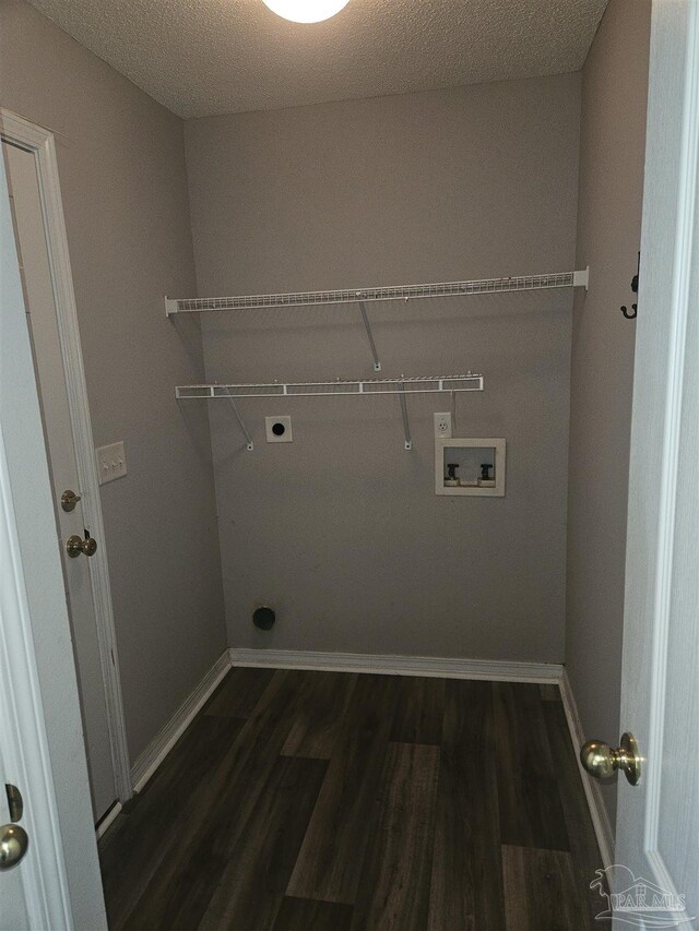 laundry area featuring hookup for a washing machine, a textured ceiling, hookup for an electric dryer, and hardwood / wood-style flooring