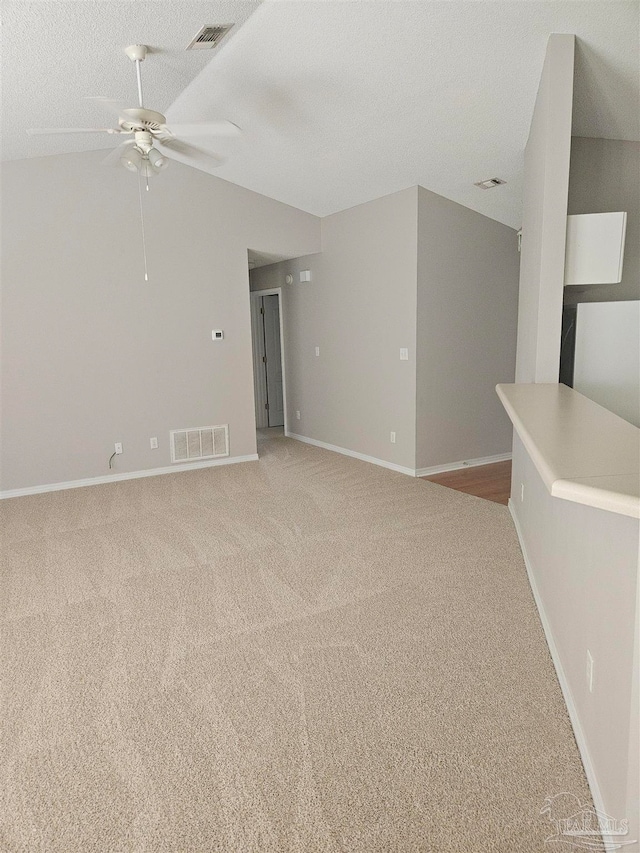 empty room with ceiling fan and light carpet