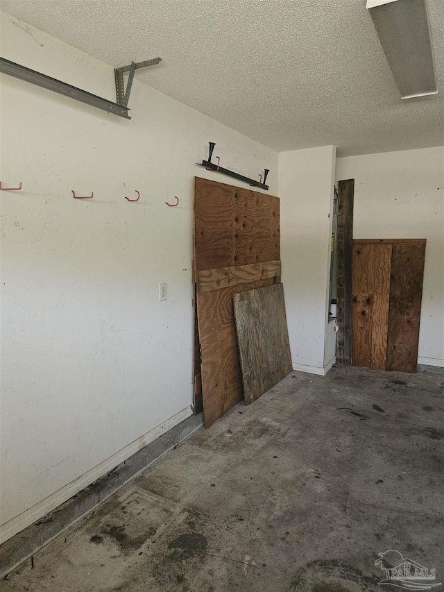 spare room featuring concrete floors and a textured ceiling