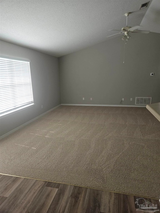 unfurnished room featuring a textured ceiling, hardwood / wood-style floors, and ceiling fan