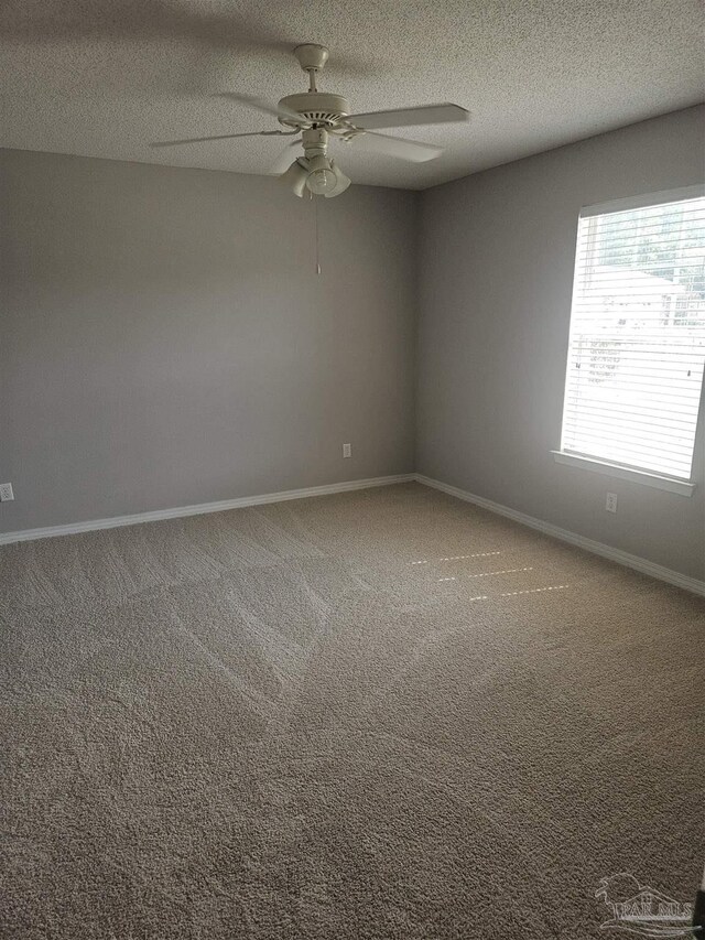 unfurnished room featuring a textured ceiling, carpet flooring, and ceiling fan