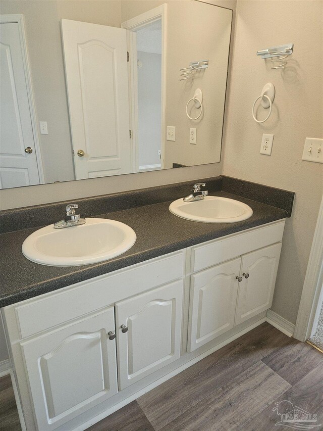 bathroom featuring double vanity and hardwood / wood-style floors