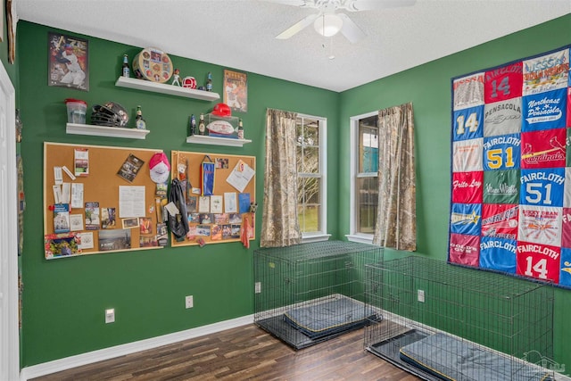 spare room featuring ceiling fan, wood-type flooring, and a textured ceiling