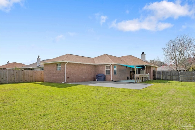 back of property with a patio and a lawn