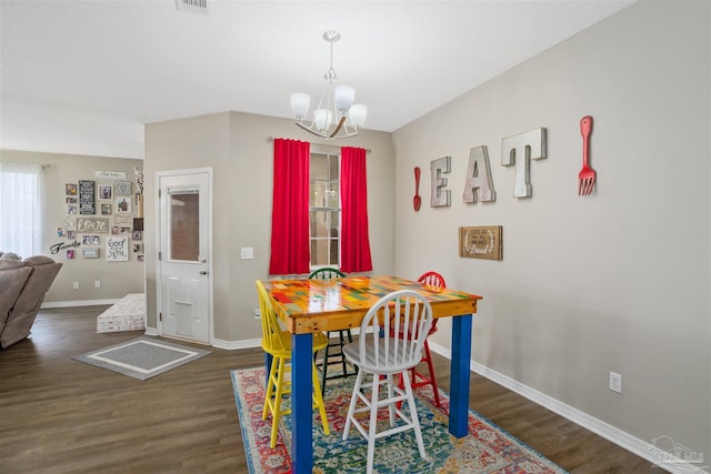 dining space featuring an inviting chandelier and dark hardwood / wood-style floors