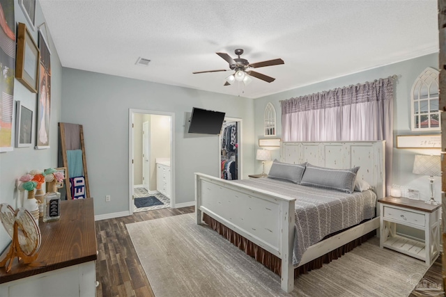 bedroom featuring a closet, a textured ceiling, connected bathroom, ceiling fan, and dark hardwood / wood-style floors