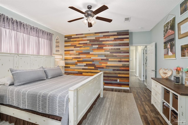 bedroom with ceiling fan and dark hardwood / wood-style floors