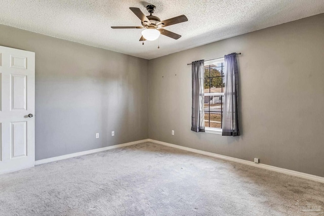 carpeted empty room featuring ceiling fan and a textured ceiling